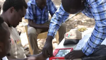 Kenyan getting their fingerprint taken as part of Huduma Namba in 2019. Credit: Getty Images.