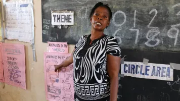 A teacher at her blackboard at the KDEC Pre-Primary School Masorie, Sierra Leone